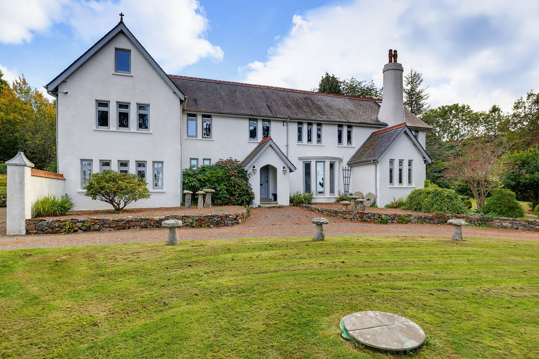 Professional exterior property photography showing a detached house with a landscaped garden