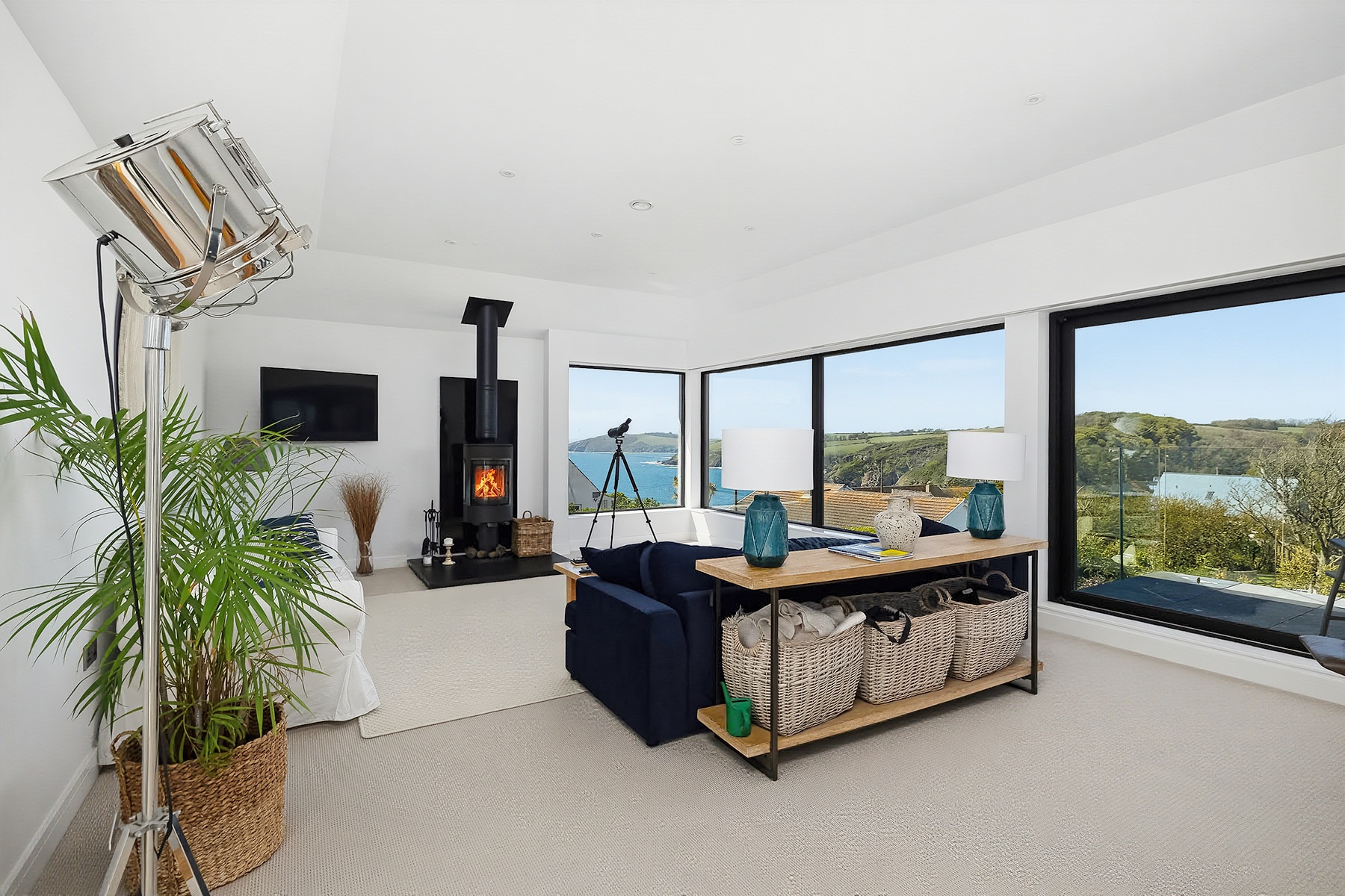 Modern living space with large windows, distant countryside views and contrasting natural interior light