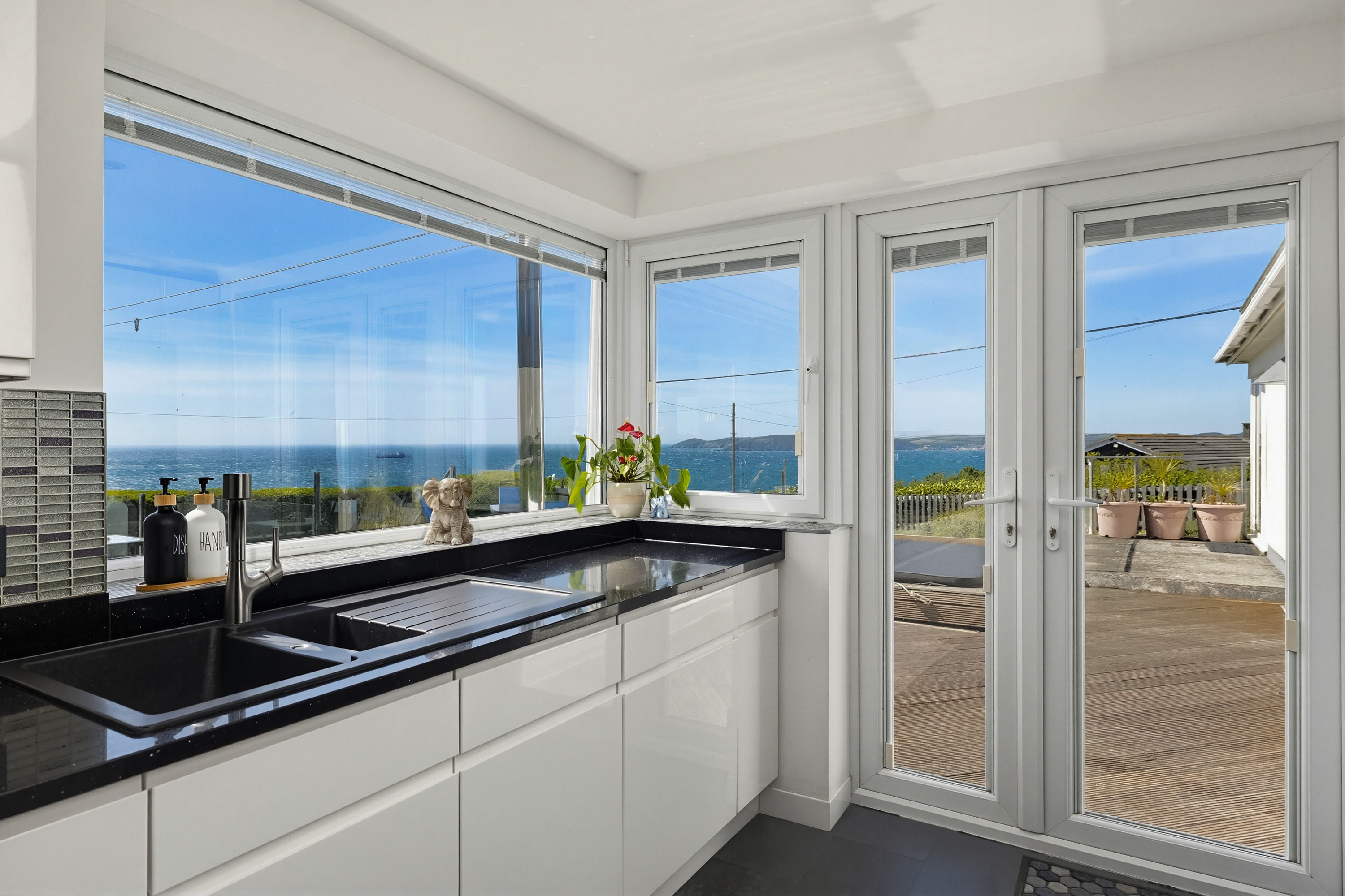 Coastal holiday accommodation kitchen with natural light and sea views