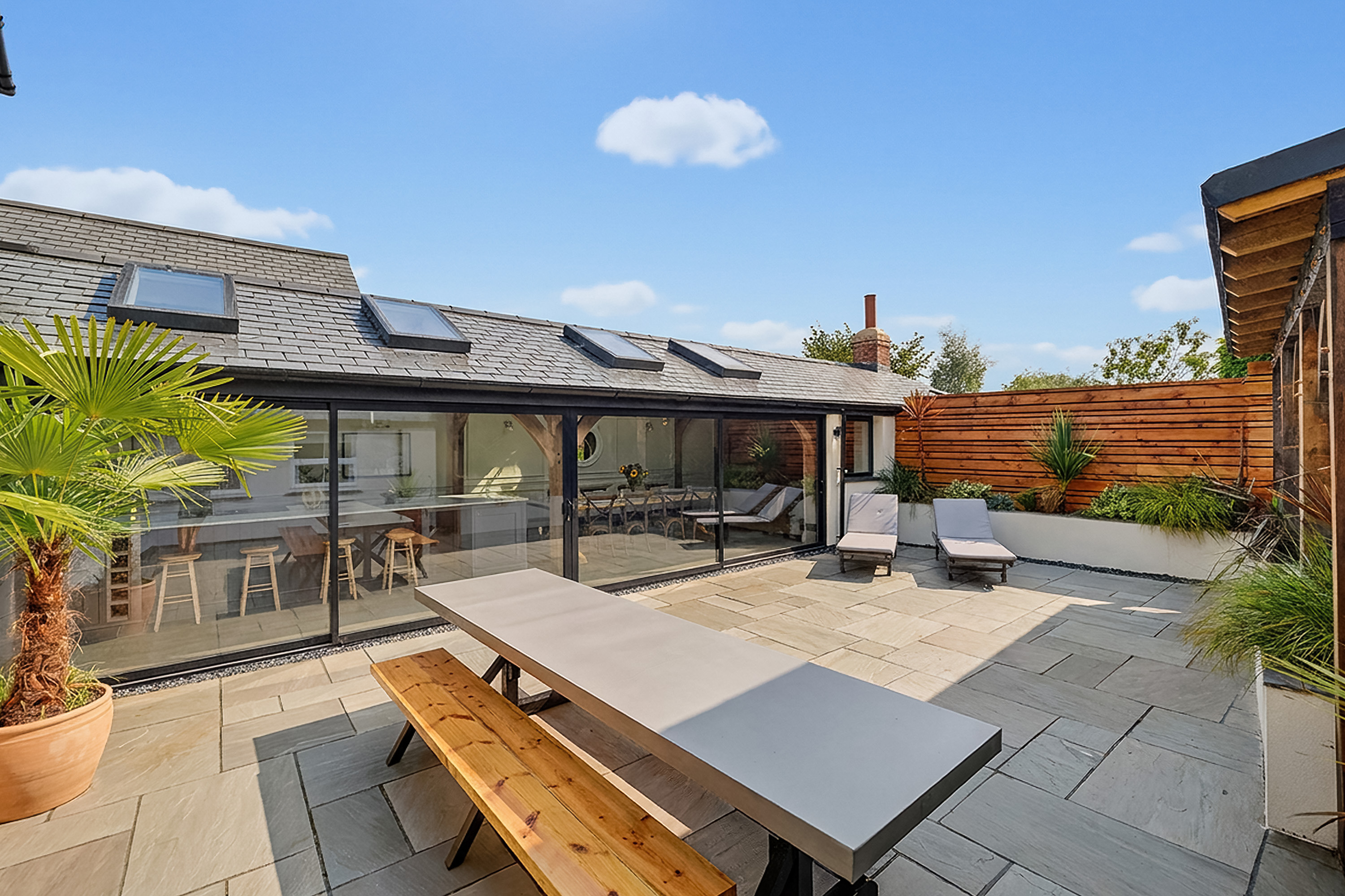 Holiday accommodation courtyard with outdoor dining and seating