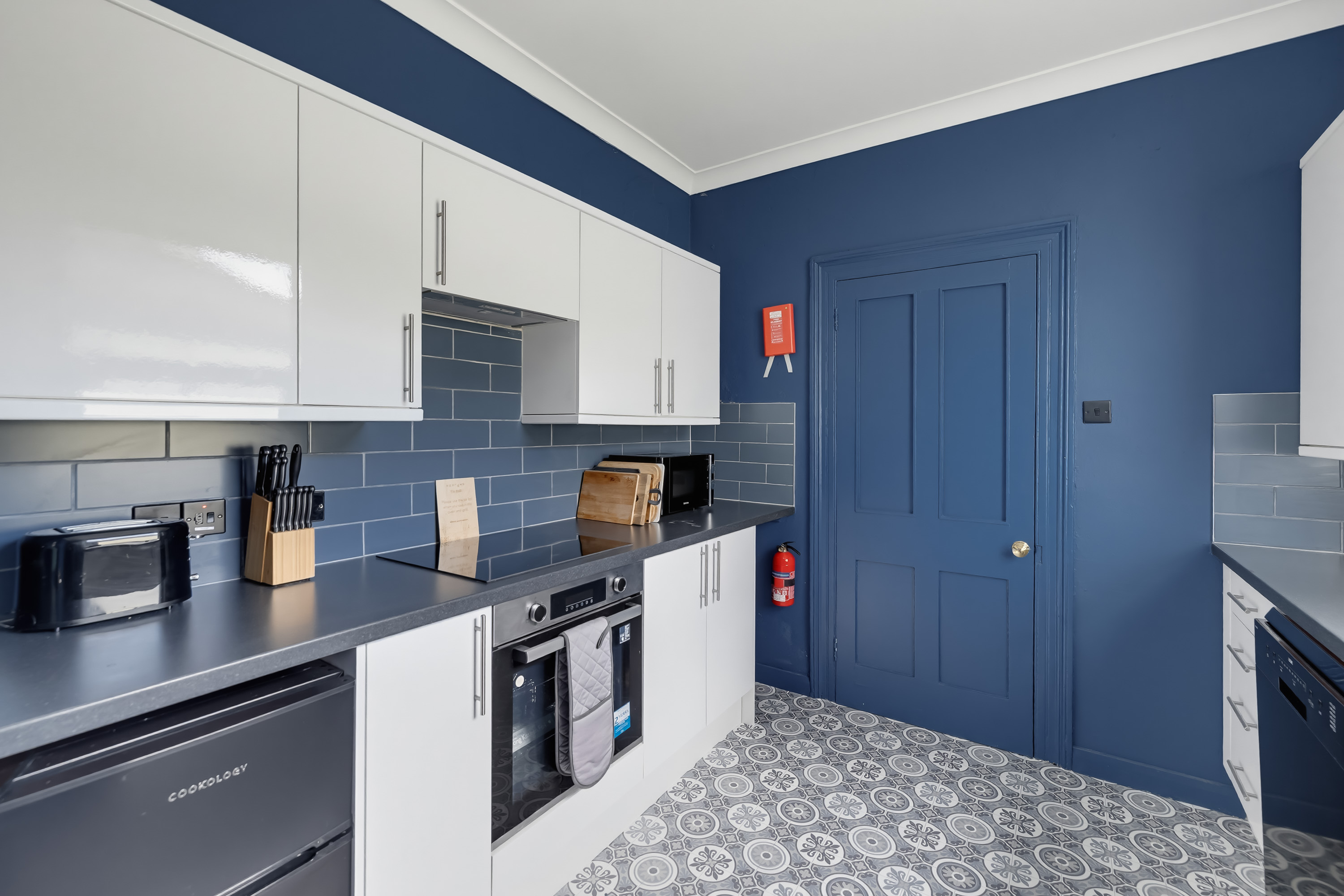 Blue kitchen in holiday accommodation professionally photographed by 241Photography