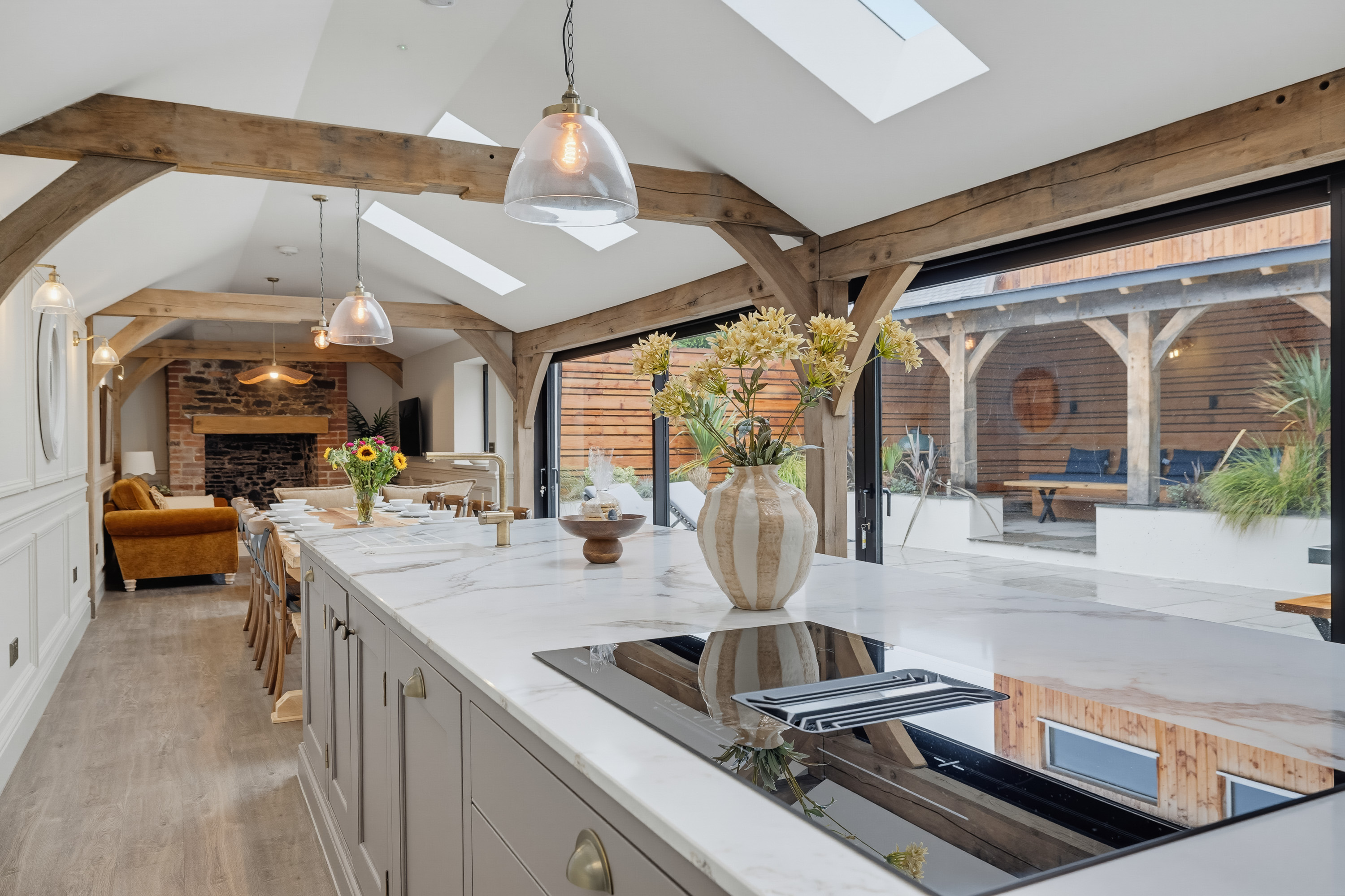 Spacious holiday accommodation kitchen with vaulted ceiling and timber beams